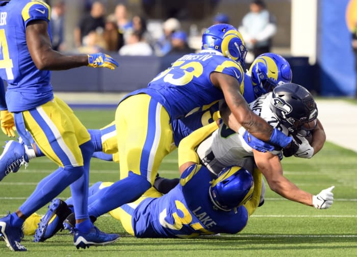 Nov 19, 2023; Los Angeles Rams linebacker Ernest Jones (53) and safety Quentin Lake (37) tackle Seattle Seahawks running back Zach Charbonnet (26). Mandatory Credit: Robert Hanashiro-USA TODAY Sports